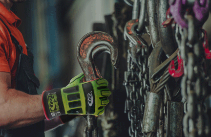 Image of text and a worker wearing Impact Protection gloves while handling equipment at work