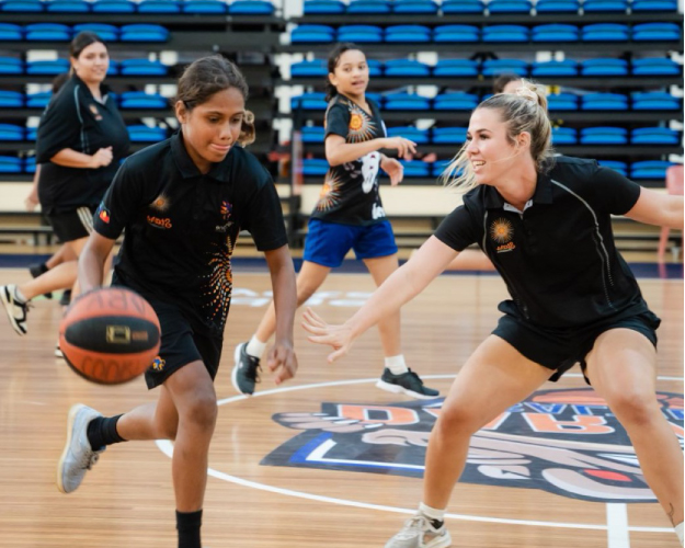 Indigenous girls playing basketball during Ansell and OneLand 2022 cultural inclusion program in Australia