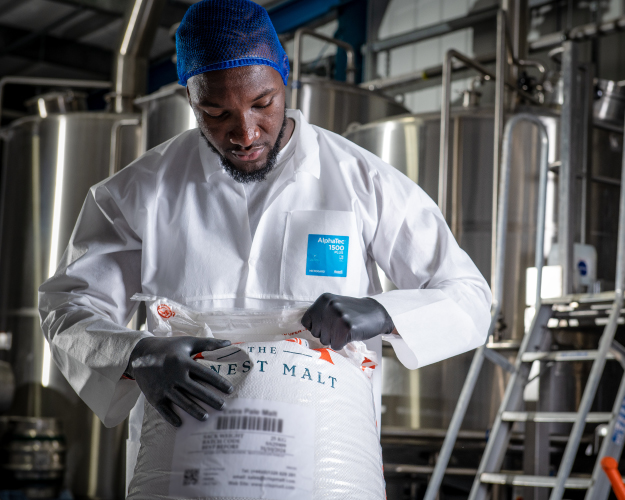 Image of a surgeon in an operating room performing surgery with Ansell's surgical gloves.