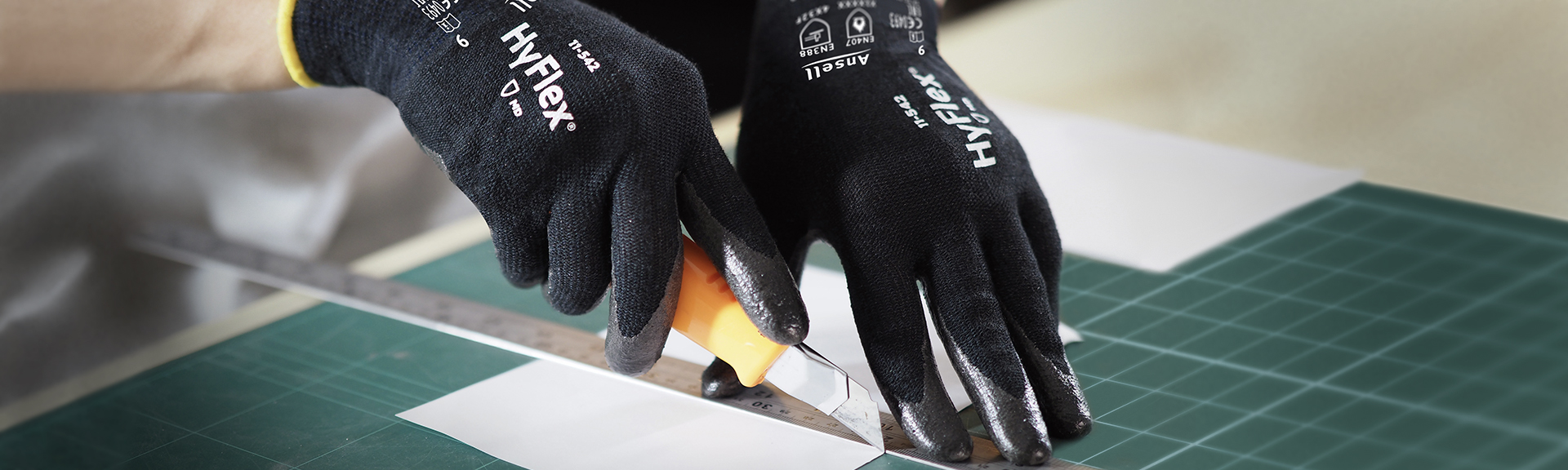 Gloved person using a tape measure