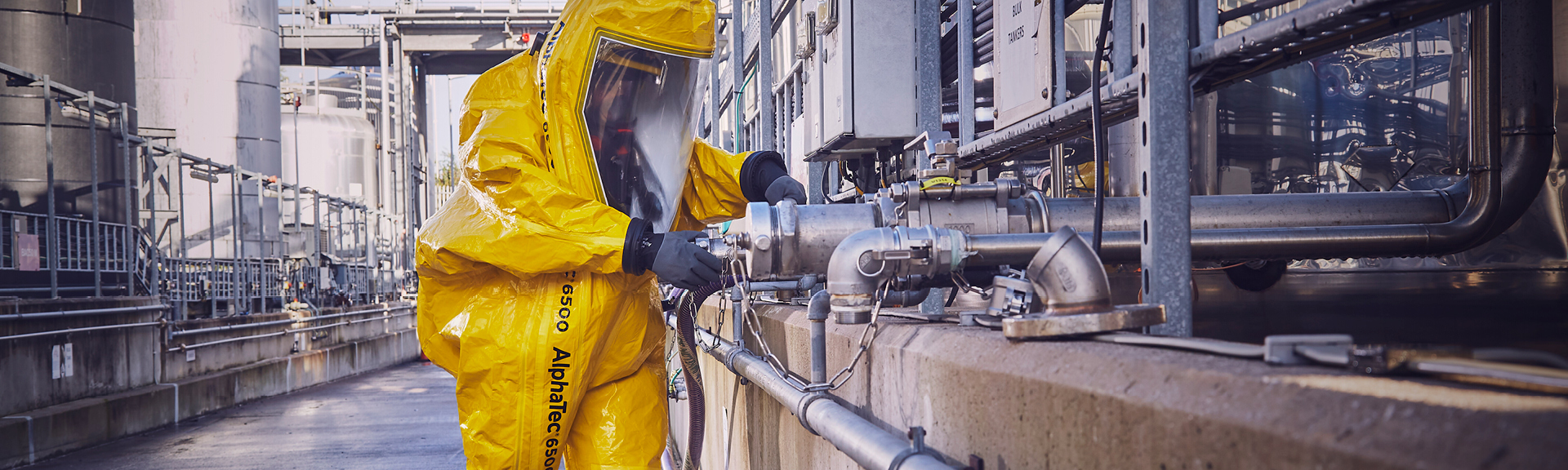 Industrial worker wearing AlphaTec protective clothing and gloves while working in extreme conditions in Oil & Gas and Mining industries