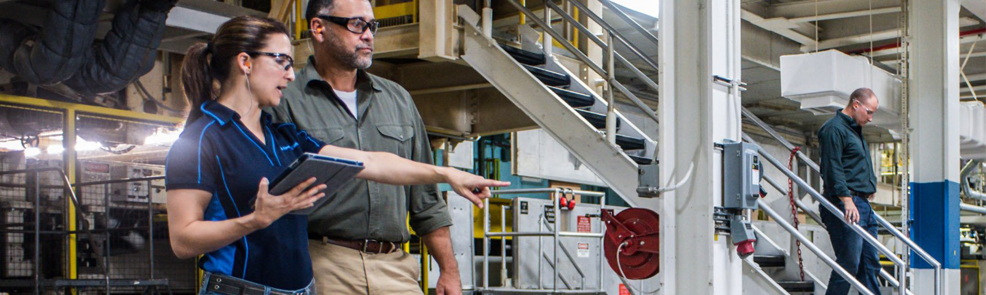 A team of professionals, including a supervisor and technicians, performing a waste walk in an industrial facility 