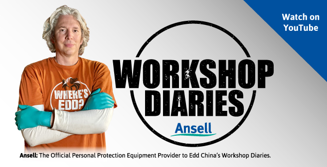 Ed China in an orange t-shirt wearing green disposable gloves with a logo of Workshop Diaries in the middle