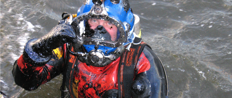 Image of diver at water surface wearing a VIKING™ diving suit ready to enter hazardous waters