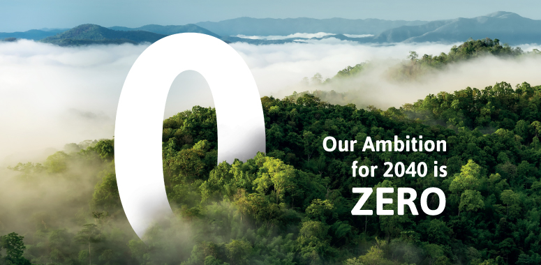 Image of the net zero logo agains lush forest with the line that says ""Our Ambition for 2040 is ZERO"