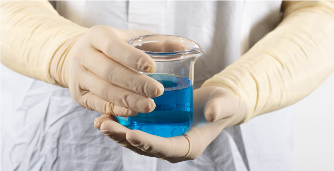 Life sciences lab technician wearing long cuff examination gloves in a cleanroom environment