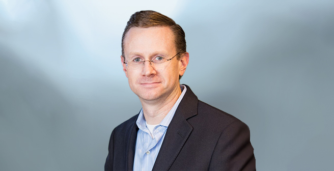 The headshot of Rob Hughes