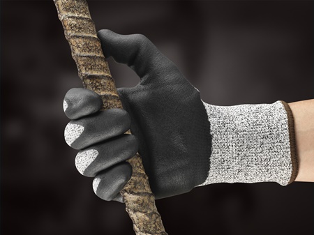 Hand wearing EDGE® 48-706 mechanical gloves gripping a work tool, ready for industrial or repair tasks