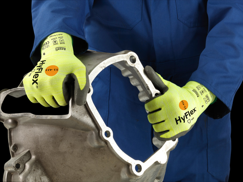 Operator wearing HyFlex® 11-423 mechanical gloves handles assembly components, ensuring safety and precision in the manufacturing process.