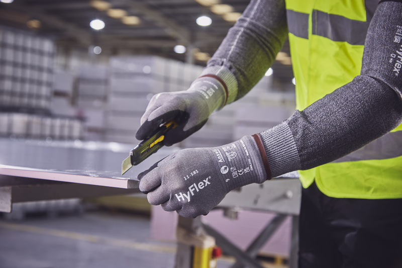 Worker wearing HyFlex® 11-581 mechanical gloves engages in metallurgy tasks, handling metal materials with precision and safety