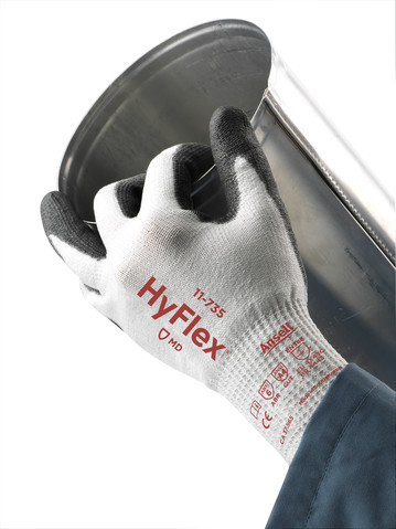 Hand wearing HyFlex 11-735 glove, holding a steel pipe