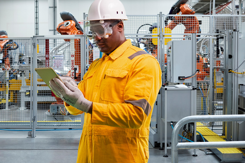 Worker operates in an industrial setting wearing HyFlex® 11-755 mechanical gloves, ensuring safe and precise handling 